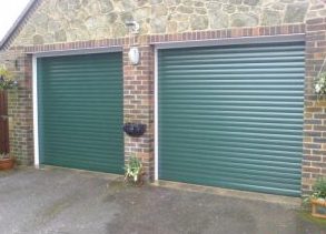 Two insulated automatic roller garage doors in Green colour